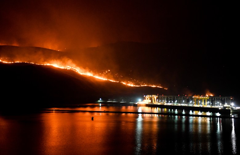 Flames from the Cold Springs Canyon/Pearl Hill wildfire encroach on Wells Dam near Azwell.