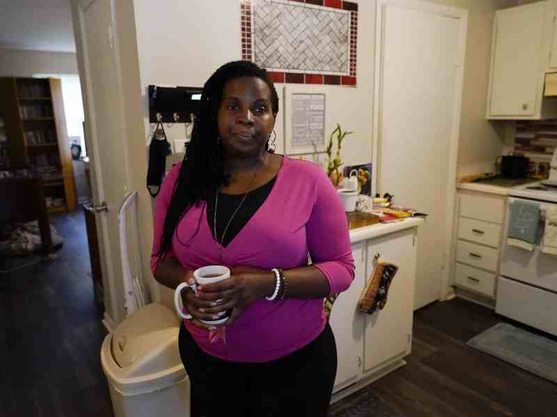 Dylyn Price of Athens, Ga., looks out a doorway from her kitchen at her rented townhome.