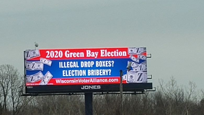 Photo of a billboard that reads "2020 Green Bay Election. ILLEGAL DROP BOXES? ELECTION BRIBERY?"