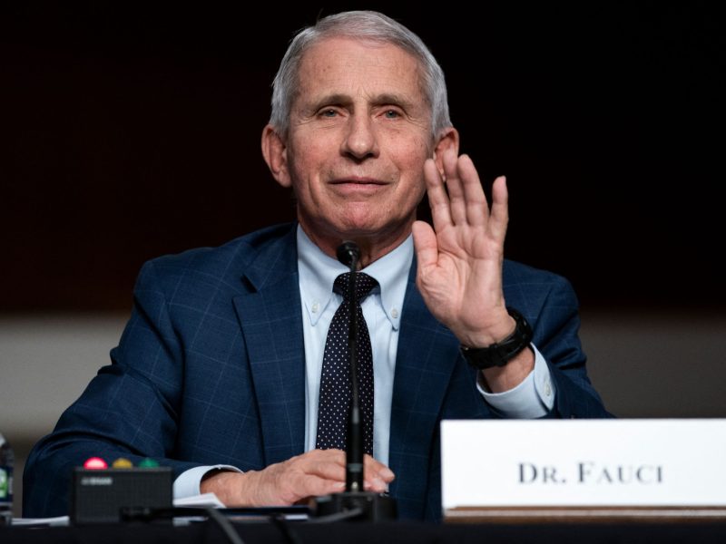 Dr. Anthony Fauci holds up his hand as he testifies during a Senate Health, Education, Labor, and Pensions Committee hearing .