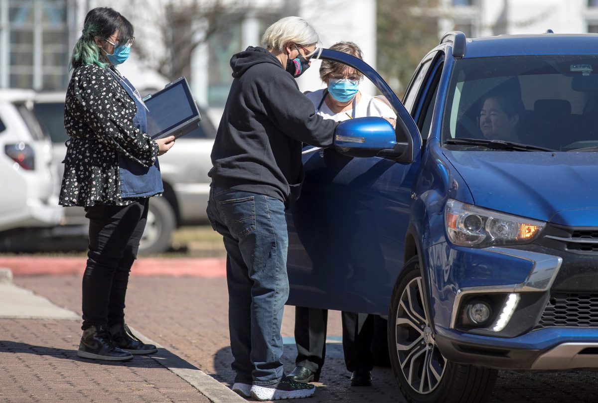 A voter with a disability gets assistance getting out of an SUV at the polling station.