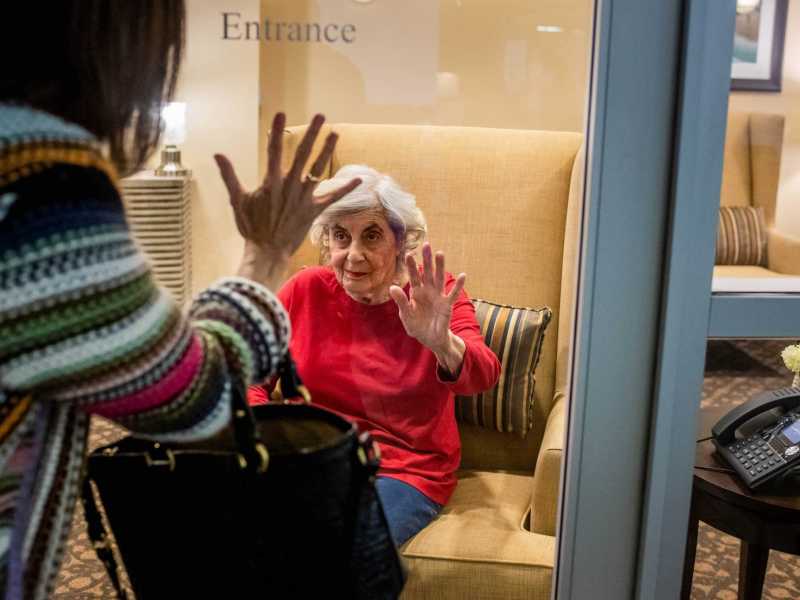 Karen Klink, of Hermosa Beach, visits her 86-year-old mother Cynthia Tachner at Silverado Beach Cities Memory Care in Redondo Beach