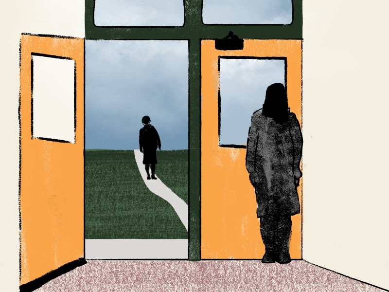 An adult stands beside an open door, looking at a student in silhouette on a path beyond.